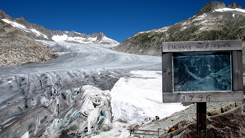 The signpost in Switzerland warns of glacier retreat. / Credit:Ray Smith/IPS